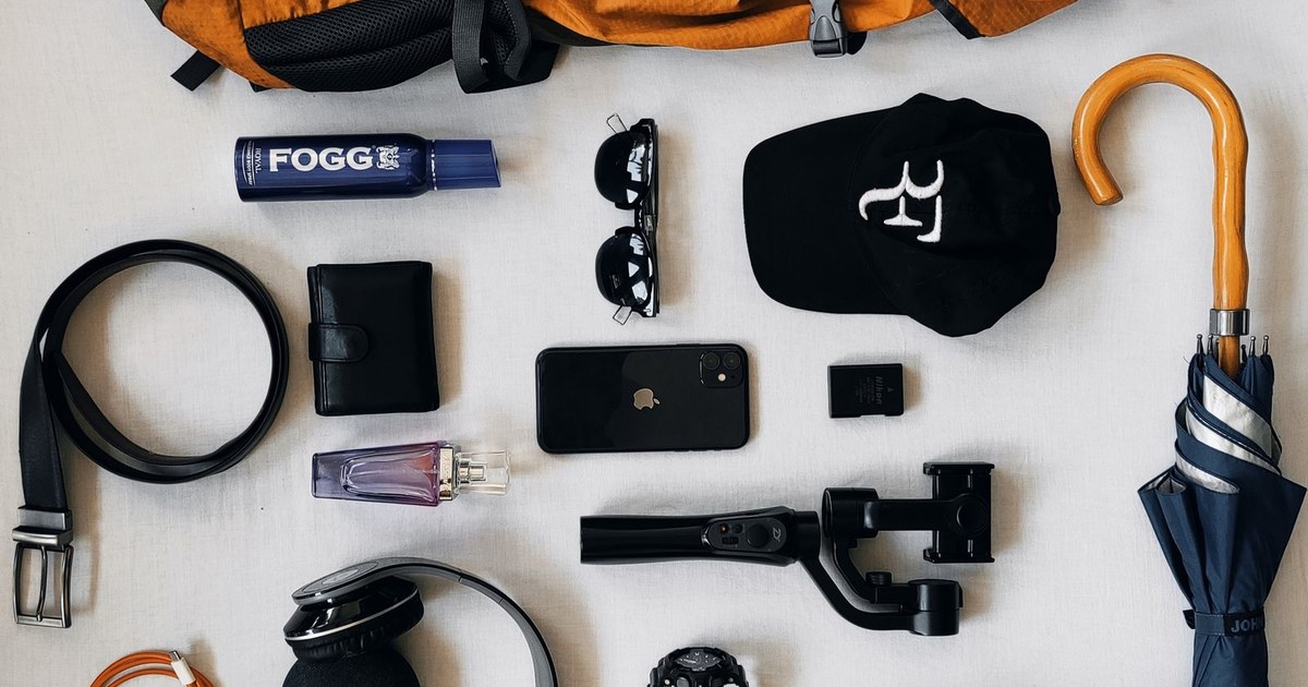 Organized gear for hiking photography, including camera, tripod, and backpack.