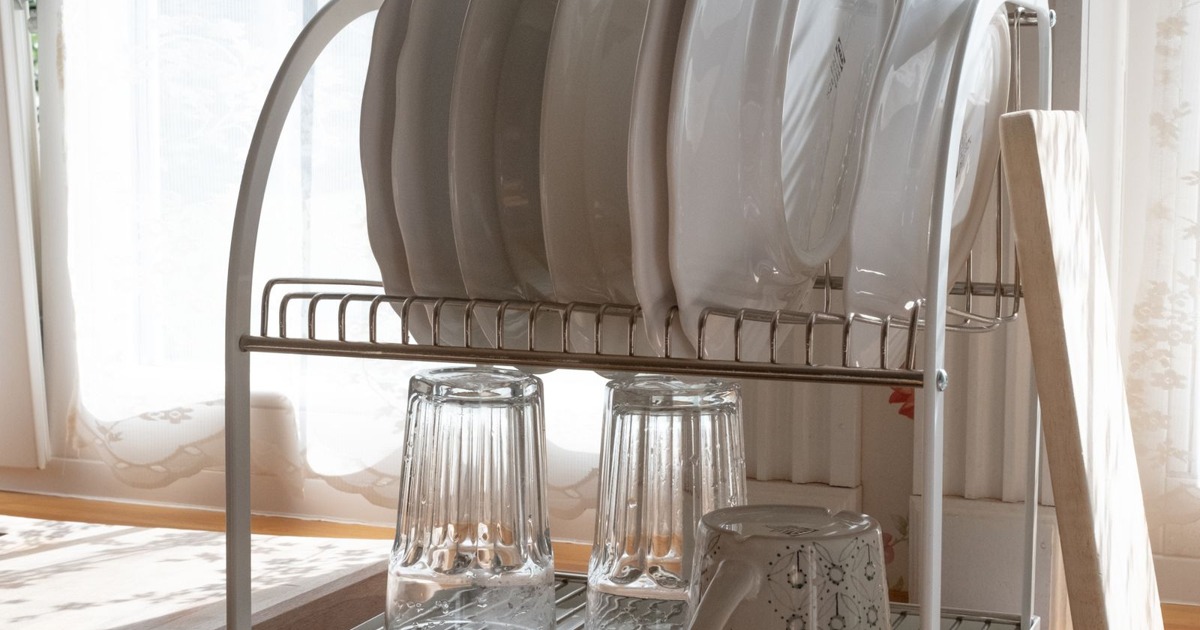 Vintage-inspired dish rack with dishes in sunlight, capturing nostalgic home vibes.