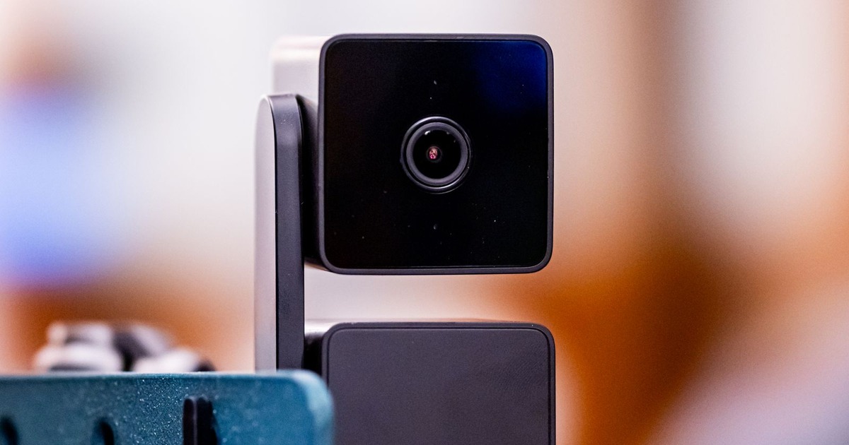 Close-up of a sleek black web camera mounted on a stand, suitable for video conferencing.