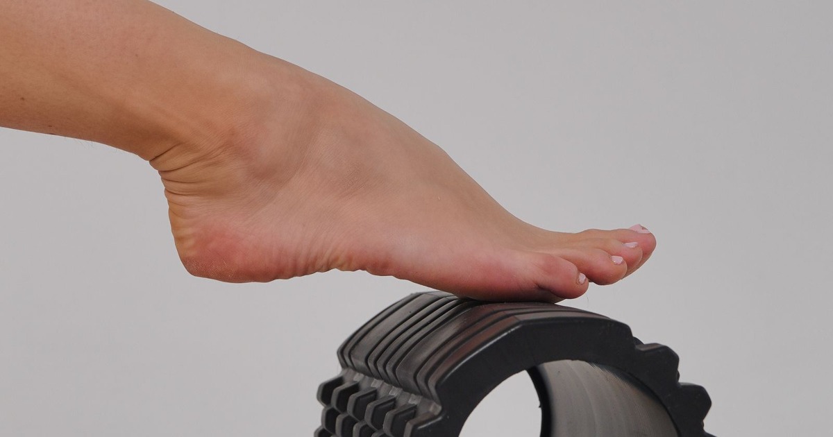 A close-up shot of a foot on a foam roller, illustrating physiotherapy and exercise.