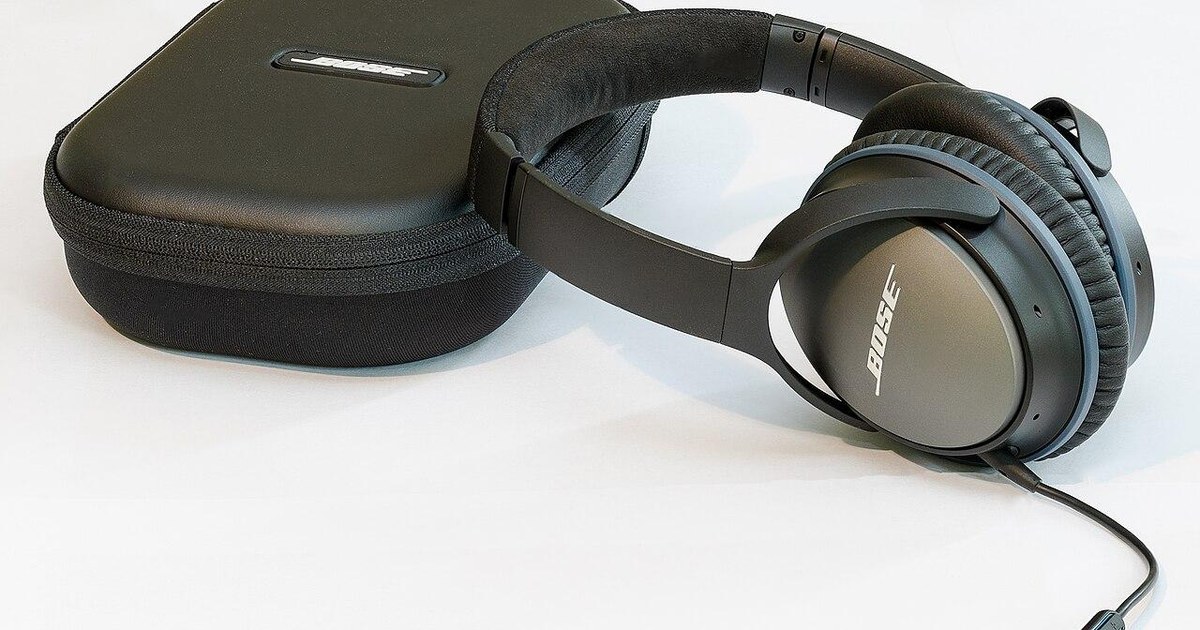 Black over-ear headphones beside their carrying case