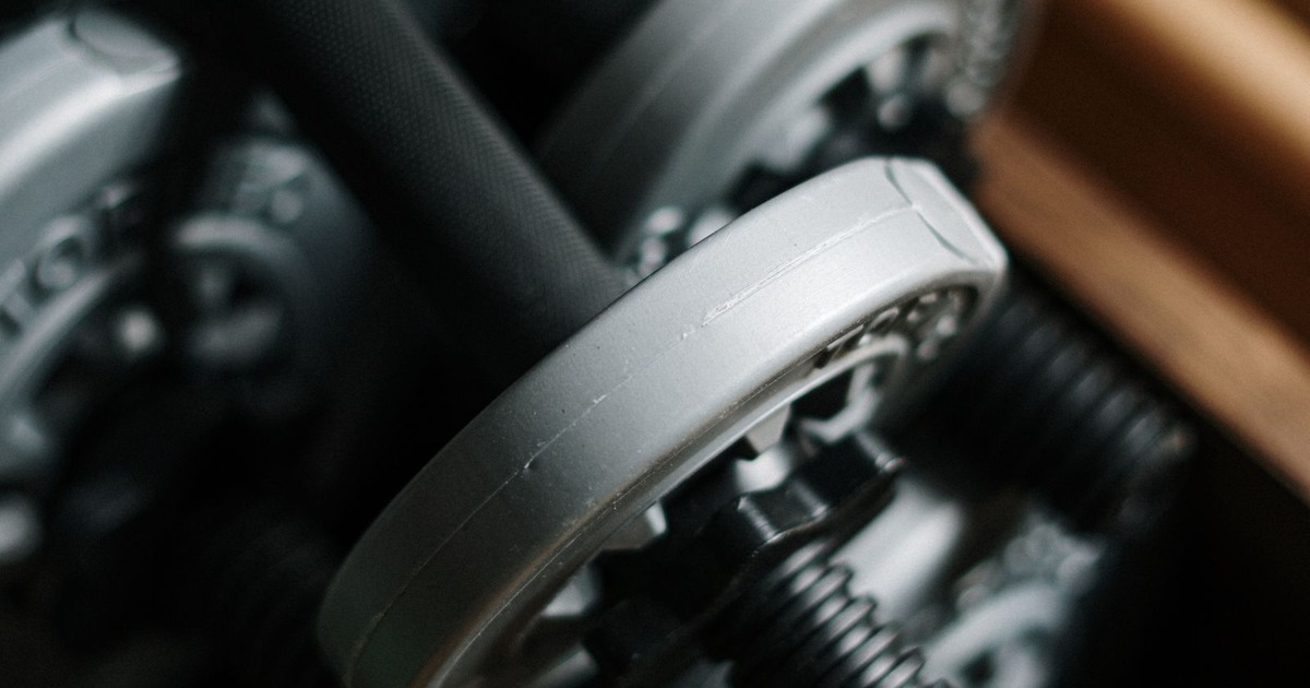 Detailed shot of dumbbells in a gym, emphasizing fitness equipment.