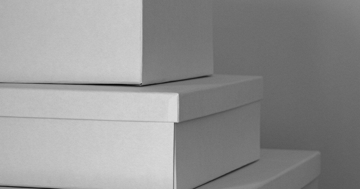 Aesthetic composition of three stacked white storage boxes in a minimalist indoor setting.