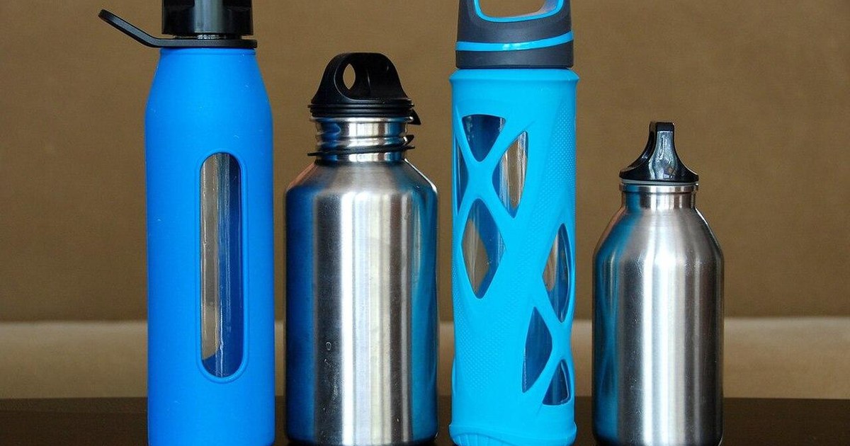 Reusable metal and glass water bottles arranged together